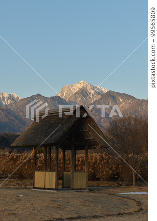 Takegawa-cho, Hokuto City, Kaikoma in winter with a thatched pavilion and the morning sun Winter: At Suisha-no-sato Park Takegawa-cho, Hokuto City, Kaikoma in winter with a thatched pavilion and the morning sun Winter: At Suisha-no-sato Park 99565809