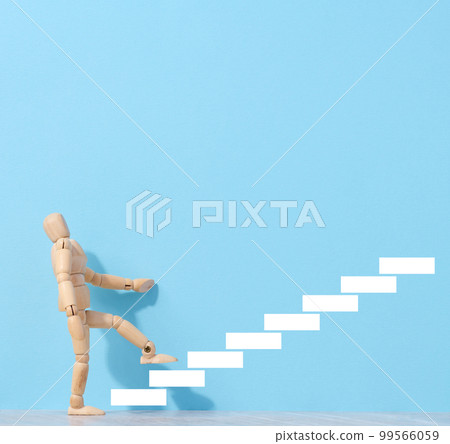 A wooden mannequin and drawn steps going up, a concept of achieving a goal, strong personality A wooden mannequin and drawn steps going up, a concept of achieving a goal, strong personality 99566059
