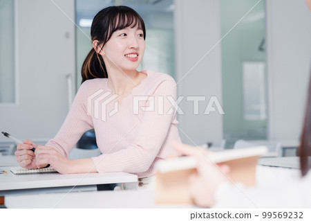 Female college students talking on campus Female college students talking on campus 99569232