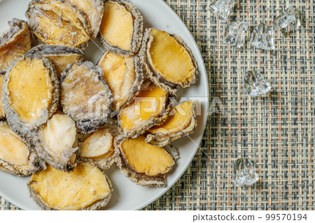 Seafood ingredients raw abalone on a plate Seafood ingredients raw abalone on a plate 99570194