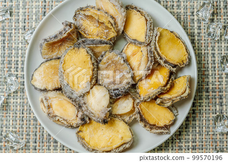 Seafood ingredients raw abalone on a plate Seafood ingredients raw abalone on a plate 99570196