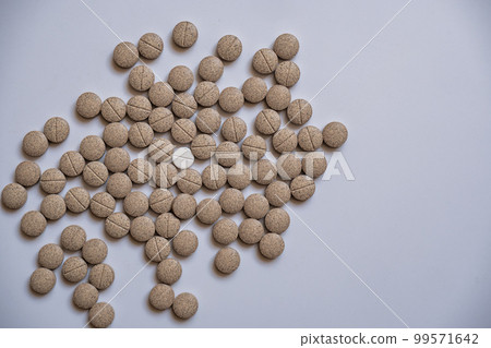 The senna herbal pill, was placed around a white pill The senna herbal pill, was placed around a white pill 99571642