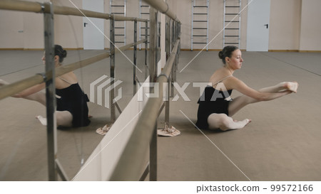 Professional ballerina doing forward bend 99572166