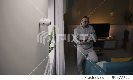 Man turns on night vision on CCTV camera Man turns on night vision on CCTV camera 99572292