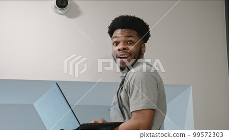 Funny worker in uniform looks at camera and smiles Funny worker in uniform looks at camera and smiles 99572303