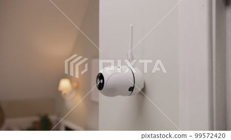 CCTV camera on wall in modern apartment 99572420