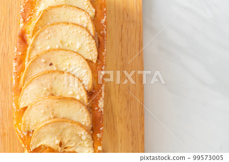 apple loaf crumbled on wood board 99573005