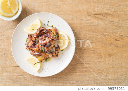grilled octopus or squid with butter lemon sauce grilled octopus or squid with butter lemon sauce 99573031