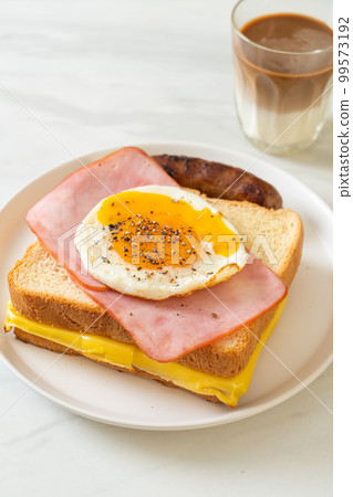 bread toasted cheese topped ham and fried egg with pork sausage bread toasted cheese topped ham and fried egg with pork sausage 99573192