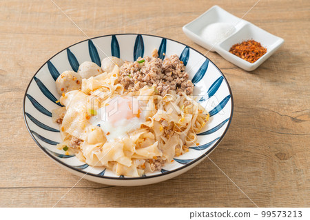 dried spicy noodles with minced pork, meatballs and egg 99573213