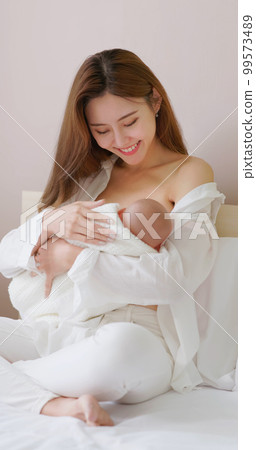 Mother breastfeeding her baby Mother breastfeeding her baby 99573489
