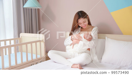 Mother breastfeeding her baby Mother breastfeeding her baby 99573490