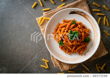 spirali or spiral pasta with tomato sauce 99573599