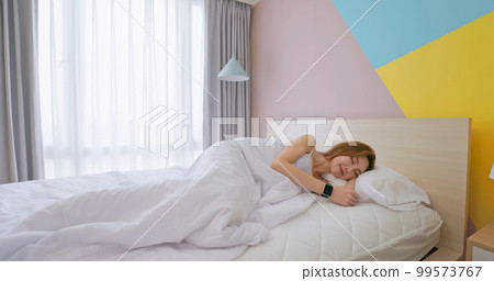 Woman sleeping with smart watch 99573767