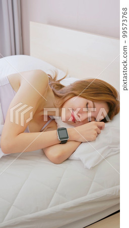 Woman sleeping with smart watch 99573768