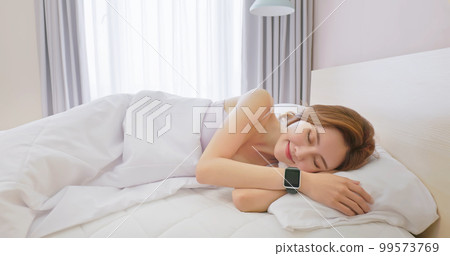 Woman sleeping with smart watch 99573769