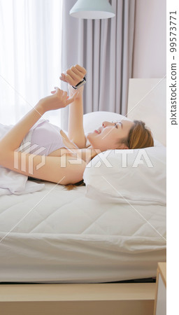 Woman wake up with smartwatch 99573771