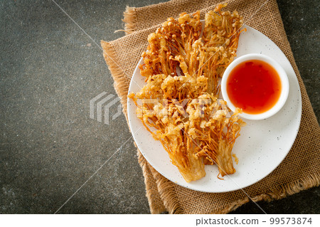deep fried enoki mushroom or golden needle mushroom with spicy dipping sauce deep fried enoki mushroom or golden needle mushroom with spicy dipping sauce 99573874