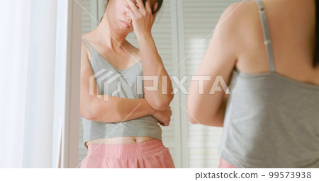 woman dissatisfied about body shape woman dissatisfied about body shape 99573938