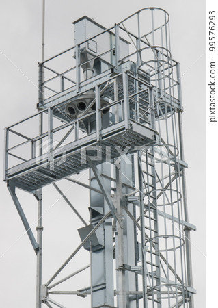 Ladder on silo for storage grain after harvest. Detail of agricultural equipments Ladder on silo for storage grain after harvest. Detail of agricultural equipments 99576293
