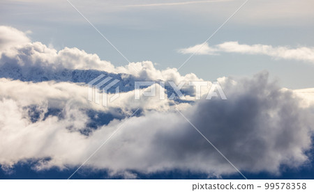 Tantalus Range covered in Snow and Clouds during Winter Season. Tantalus Range covered in Snow and Clouds during Winter Season. 99578358