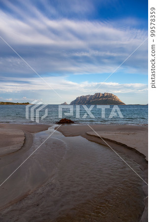 Rocky and Sandy Beach in Porto Istana, Sardinia, Italy. Tavolara Island in Background. Rocky and Sandy Beach in Porto Istana, Sardinia, Italy. Tavolara Island in Background. 99578359