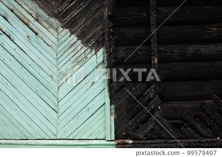 Black half burned blue wooden house Black half burned blue wooden house 99578407