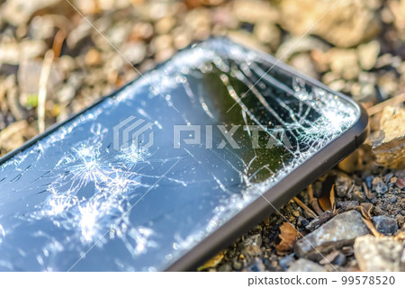 A smartphone with a broken screen when dropped 99578520
