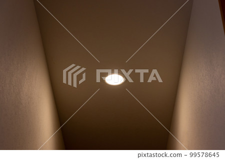 Small downlight in the ceiling of the corridor 99578645