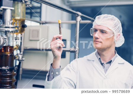 Scientist man working Cannabis CBD oil extraction for medical Science lab. Hemp oil extraction Thin Film Distillation Machine in Laboratory Plants Process. 99578689