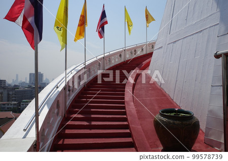 Wat Saket in Thailand with beautiful contrast between white walls and red spiral staircase Wat Saket in Thailand with beautiful contrast between white walls and red spiral staircase 99578739