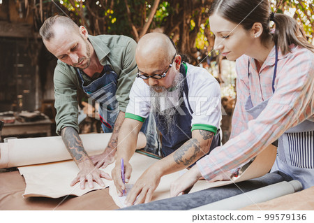 group of people leather handcraft artist and designer working together to selection best leather for new products 99579136