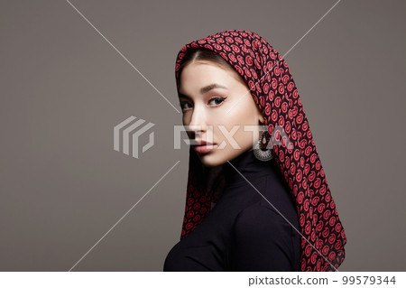 beautiful young woman in color veil and jewelry. beauty girl in colorful hijab 99579344
