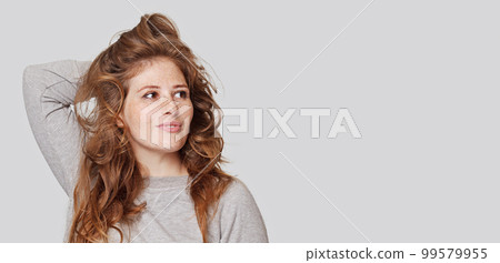 Portraits of a charming redhead woman.  99579955