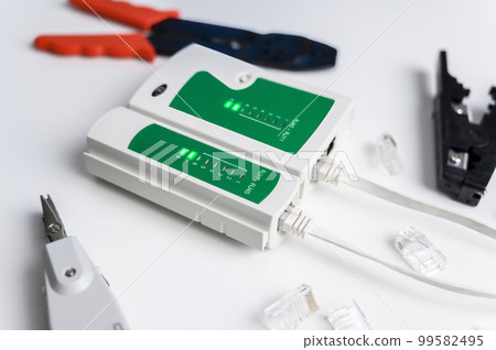 Cat6 RJ45 cable network tester. Twisted pair test tool on the desktop. 99582495