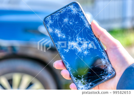 Smartphone car background with a broken screen when dropped Smartphone car background with a broken screen when dropped 99582653