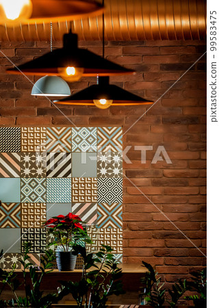 Lamps and chandeliers in the restaurant with warm light Lamps and chandeliers in the restaurant with warm light 99583475