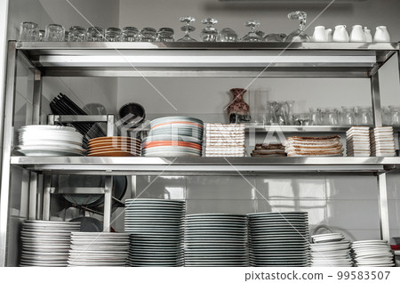 Clean dishes in the restaurant on the shelves 99583507