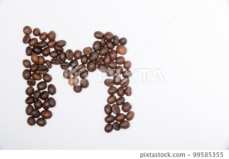 M is a capital letter of the English alphabet made up of natural roasted coffee beans that lie on a white background. 99585355