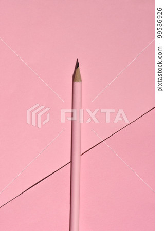 High Angle View of sharp wooden pencil on pink background.  99586926