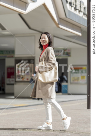 Arafif woman walking in the city Portrait 99587513