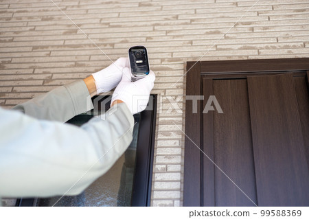 About to install a security camera near the entrance of a detached house 99588369