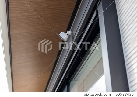 Security camera attached to a detached house Security camera attached to a detached house 99588456