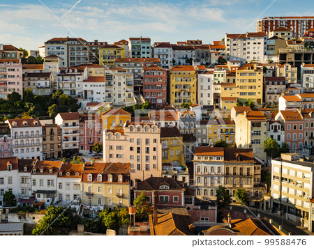 Colored facades of the houses of Coimbra, roman city located on a hill by the Mondego River, Portugal 99588476