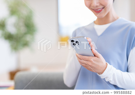 A woman who operates a smartphone. A woman who operates a smartphone. 99588882