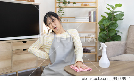 Housewife with back pain and shoulder pain from doing hard housework on weekends, Big cleaning, Housework, Daily routine , Cleaning spray and rags, Spray alcohol, Clean up. Housewife with back pain and shoulder pain from doing hard housework on weekends, Big cleaning, Housework, Daily routine , Cleaning spray and rags, Spray alcohol, Clean up. 99589965