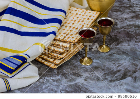 Passover matzo Jewish holiday celebration of matzah with cups red kosher wine served during kiddush Passover matzo Jewish holiday celebration of matzah with cups red kosher wine served during kiddush 99590610