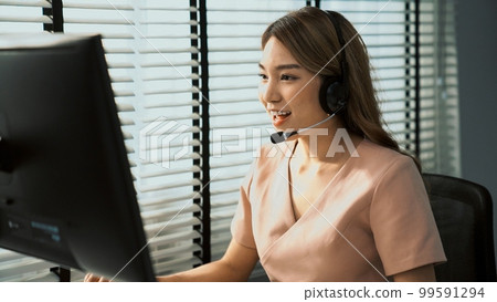 Competent female operator working on computer and while talking with clients. Competent female operator working on computer and while talking with clients. 99591294