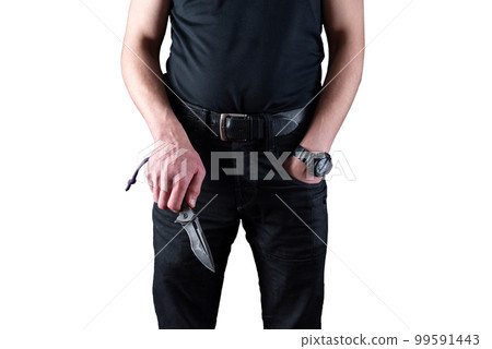 A man in black clothes with a knife in his hands. A man holds a folding knife in his hand. Man and knife on a white background. 99591443