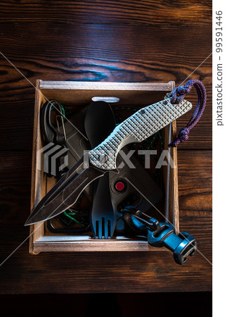 Folding knife in a box. Knife and miscellaneous everyday items. Wooden box and pocket knife. EDC knife. 99591446